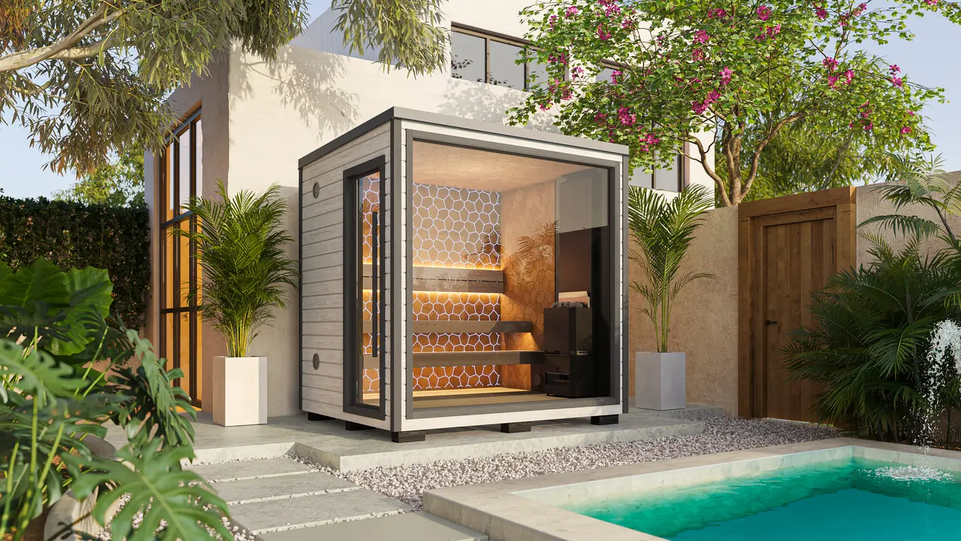 A white Mini sauna beside a turquoise plunge pool in a courtyard